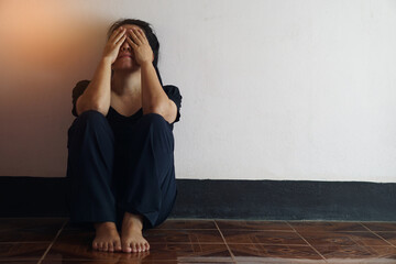 Depressed sad girl sits on the floor and cry in dark room during self isolated or quarantine at...