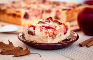 a piece of apple pie with creamy filling cutting into squares close up