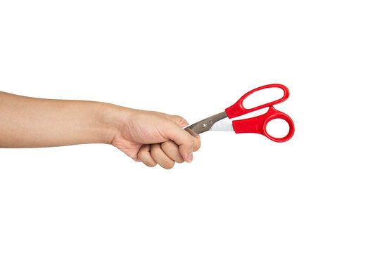Close up of hand holding scissors isolated with white background