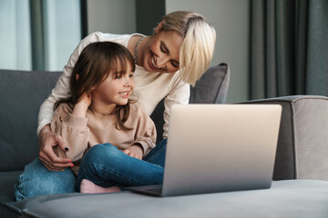 Happy young mother and her little daughter