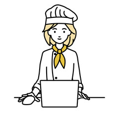 デスクで座ってPCを使っている調理師の女性
