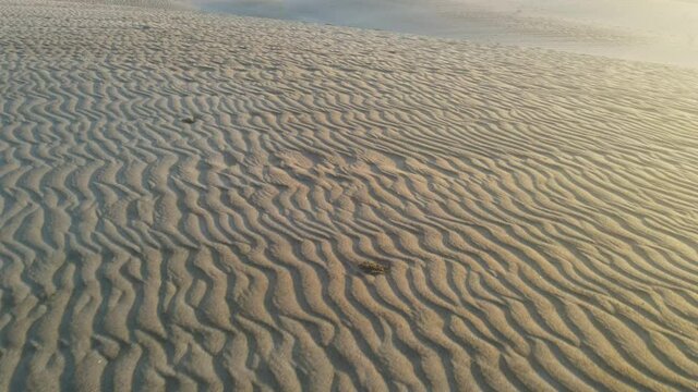 Sigatoka Sand Dunes National Park, Fiji. Flying forward over desert sand with rippled pattern texture.