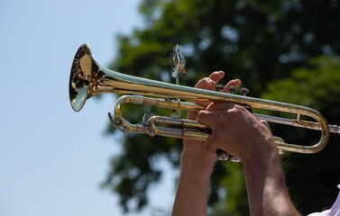 playing a brass instrument. military band performs at the festival