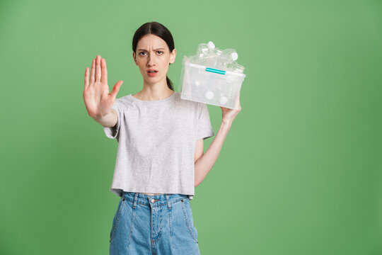 Young woman carrying a plastic container