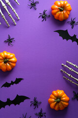 Halloween poster with festive decorations, pumpkins, spiders, skeletons hands, bats on purple...