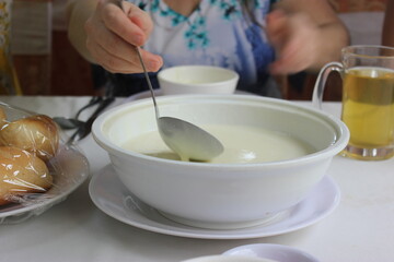 Cheese cream-soup in a white plate and tea