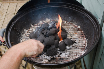 Man lighting fire on the bbq grill 