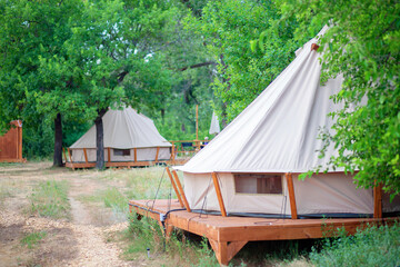 View of modern camping tents in the glamping area. Camping tent with all the amenities.