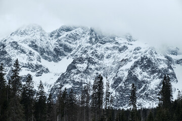 Scenery High Tatras view in the winter. Mountains covered by clouds.