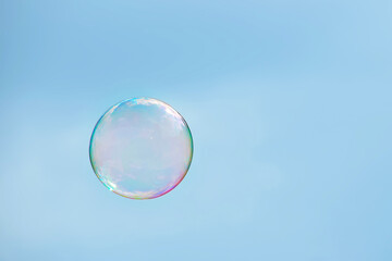 One soap sud bubble over blue sky
