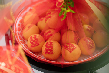 mandarin orange in Chinese wedding ceremony with red net and Chinese tray 