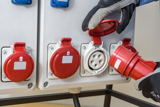 Industrial sockets and plug on distribution board. Construction site electricity, temporary energy supply
