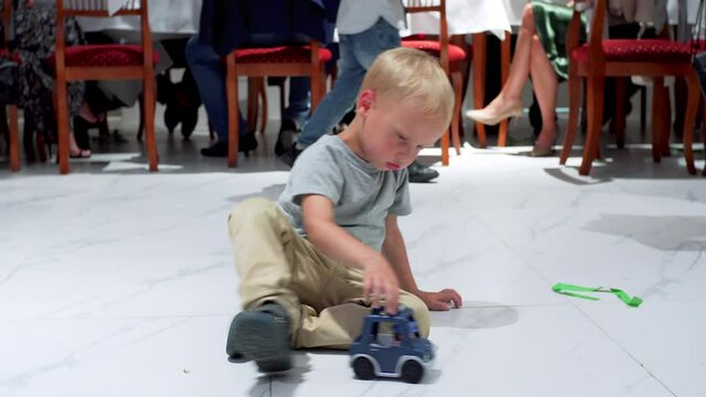 Child playing on floor in public place. Freedom of self expression.