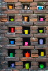 colorful cups in a stone wall