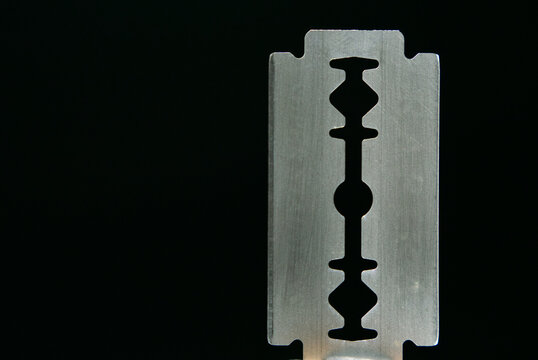 Razor blade on black background. Macro shooting