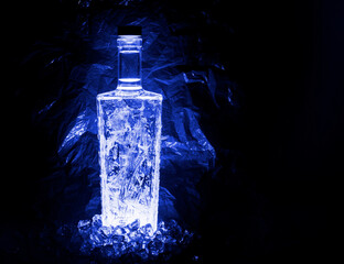 tall rectangular bottle with rounded corners. ice patterns on the walls, blue crumpled background...