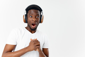 Fototapeta premium man african appearance with open mouth headphones listening to music emotions isolated background