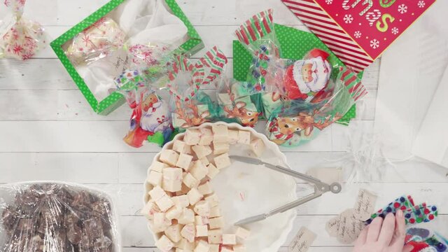 Flat lay. Step by step. Packaging homemade candy cane fudge into small gift bags.