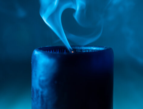 Candle smoking in the ble light. macro close up