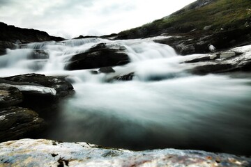 Dramatic long exposure shot of rapids and rocks