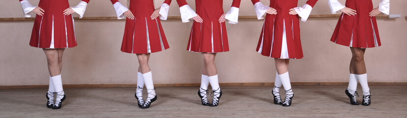 Close-up of a group of woman dancing traditional Irish dances. Legs of a dance ensemble