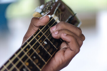Left hand on the fretboard putting the chord to play.