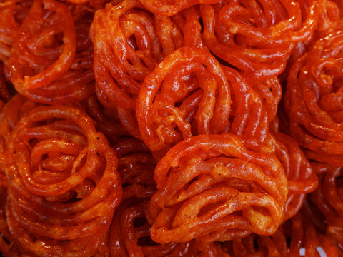Imarti,  Amriti,  Jaangiri.  Popular Indian sweet made by deep frying lentil batter which is then soaked in cardamom and rose flavored sugar syrup, Visakhapatnam, India