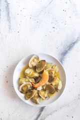 Artichokes with clams and prawns, typical traditional Spanish food for Christmas and New Year