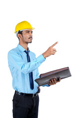 Young Indian male engineer wearing yellow color hard hat on white background.