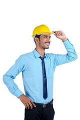Young Indian engineer wearing yellow color hard hat and giving successful gesture.