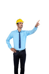 Young Indian male engineer wearing yellow color hard hat on white background.