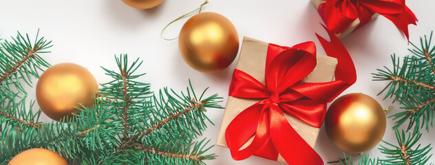 Christmas or Happy New Year composition made of red gift boxes, fir tree, holiday decorations on white background. flat lay. top view. Banner