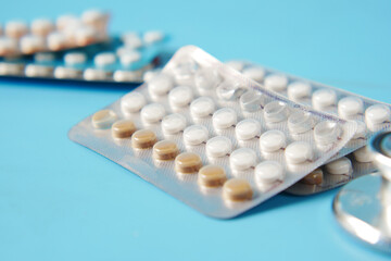birth control pills on wooden background, close up 