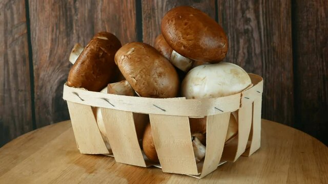 Fresh Brown and White Champignon Mushhrooms in backet on wooden background, Royal champignon mushrooms