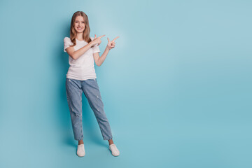 Portrait of positive lovely casual lady hands fingers direct empty space demonstrate banner on blue background