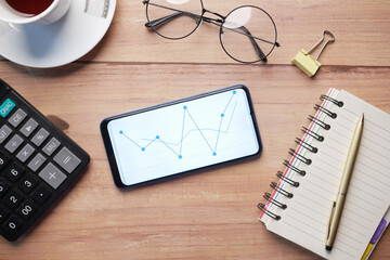 top view of stock chart display on smart phone on table 