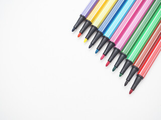 Close up color pen different array on white isolated top view copy space