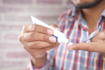 Man applying antibiotic cream close up
