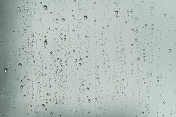 Raindrops on the glass in the rainy weather.