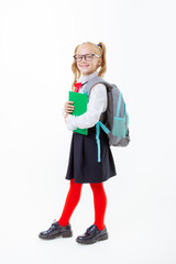 a little schoolgirl girl in a school uniform holds a book isolated on a white background
