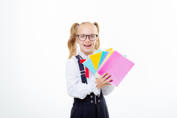 a little schoolgirl girl holds notebooks on a white background isolated