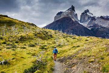 Traveler with Backpack hiking in Torres del Paine national park, Patagonia, Chile