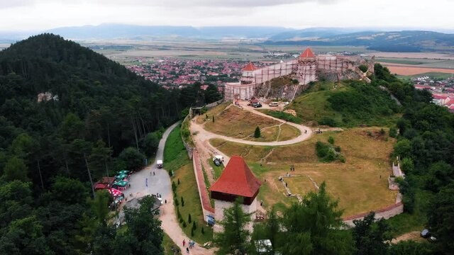 Beautiful Rasnov fortress in restoration process, Rasnov city in the background. Summer 2021