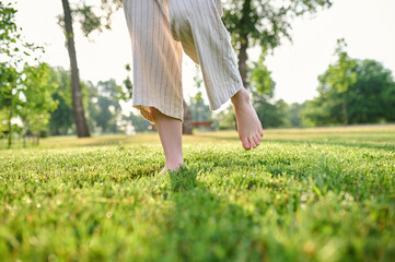 Womens legs joyfully moving on grass