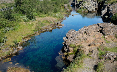 Clear water and rock formations at Thingvellir, Iceland, on a sunny day 