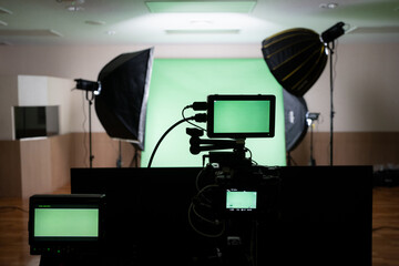 Selective focus of three screen attaching with camera while capturing a green screen cloth backdrop...