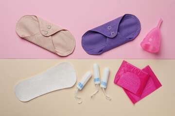Reusable and disposable menstrual hygiene products on color background, flat lay
