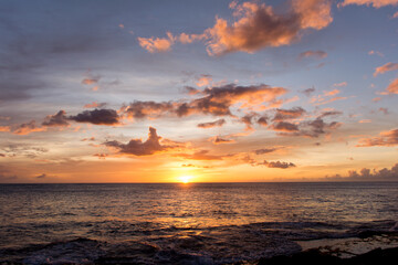 Fototapeta na wymiar Rainbow Hawaiian cloudy sunset with silhouettes