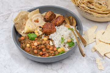 Indian vegan bowl with chckpeas, rice, kofta and chapati