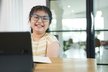 Girl children using laptop computer, studying through online.